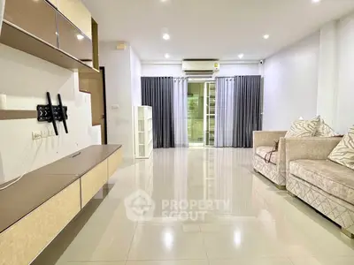 Spacious modern living room with sleek furniture and large windows