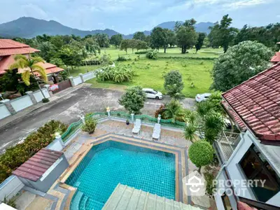 Stunning aerial view of luxury villa with private pool and lush green landscape