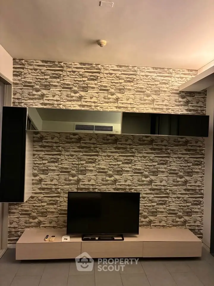 Modern living room with stylish stone accent wall and sleek TV setup