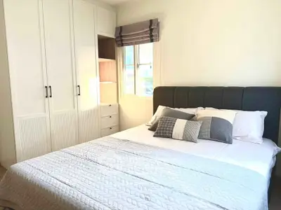 Cozy bedroom with modern decor and ample natural light