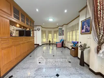 Spacious living room with elegant wood paneling and large windows