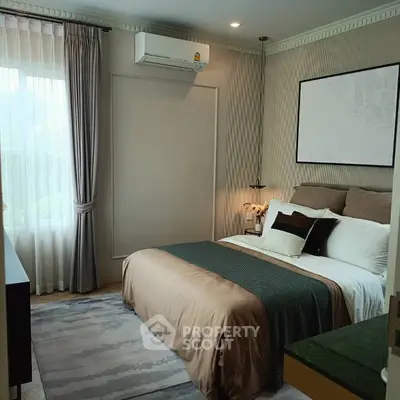 Elegant bedroom with stylish decor and natural light, featuring a cozy bed and modern air conditioning.