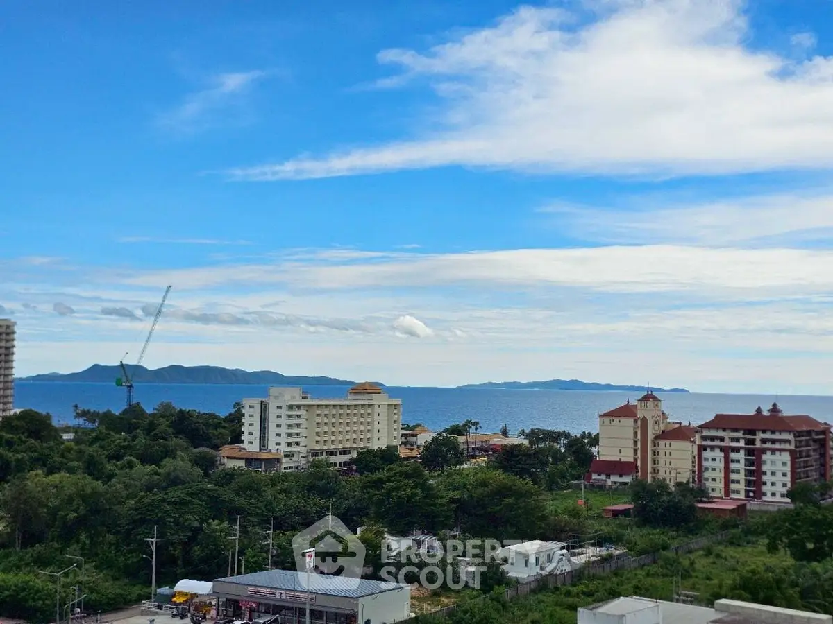 Scenic ocean view from a high-rise building overlooking lush greenery and coastal skyline.