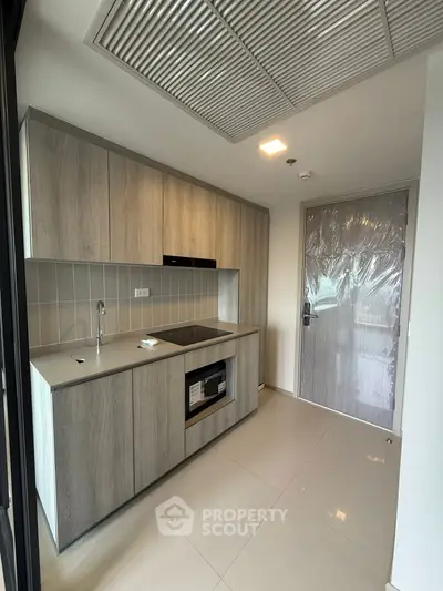 Modern kitchen with sleek cabinetry and built-in appliances in a contemporary apartment.