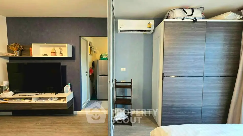 Modern apartment interior with TV, air conditioning, and stylish storage solutions.