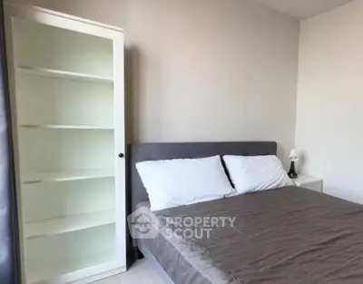 Modern bedroom with cozy bed and stylish bookshelf