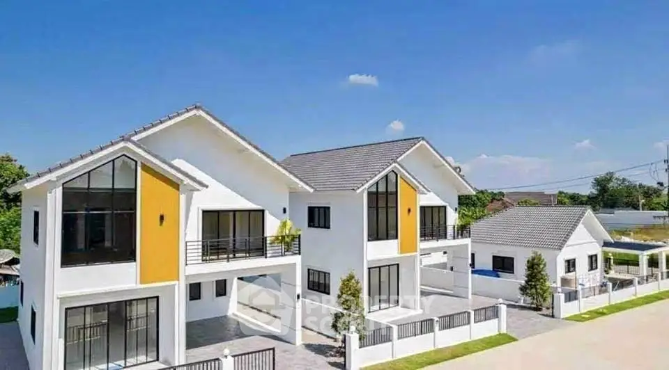 Modern two-story white house with large windows and spacious driveway