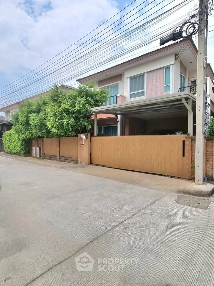 Charming two-story house with modern design and lush greenery in a serene neighborhood.