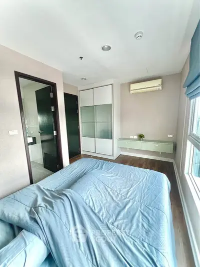 Spacious bedroom with modern design, featuring large windows and built-in storage, perfect for comfortable living.