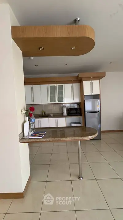 Modern kitchen with sleek cabinets and stainless steel appliances in open layout.