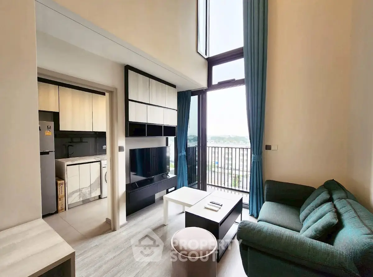Modern living room with high ceiling and balcony view
