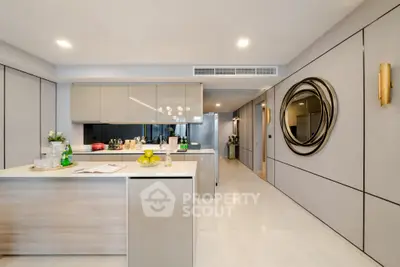 Modern kitchen with sleek cabinetry and open layout, featuring a stylish island and contemporary decor.