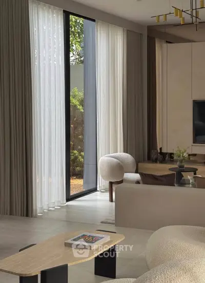 Luxurious modern living room with elegant furniture and floor-to-ceiling windows