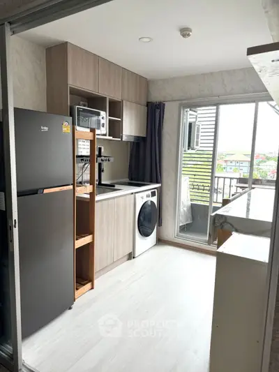 Modern kitchen with appliances and balcony view in stylish apartment