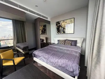 Luxurious bedroom with city view, modern decor, and elegant furnishings in high-rise apartment.
