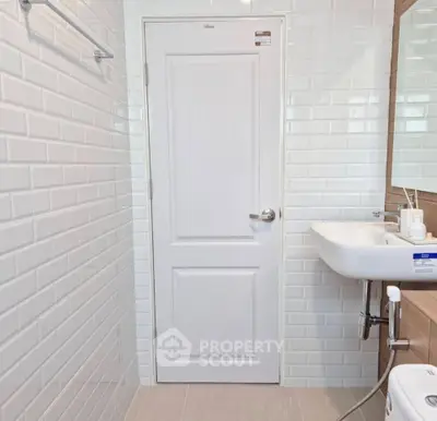 Modern bathroom with white subway tiles and sleek fixtures