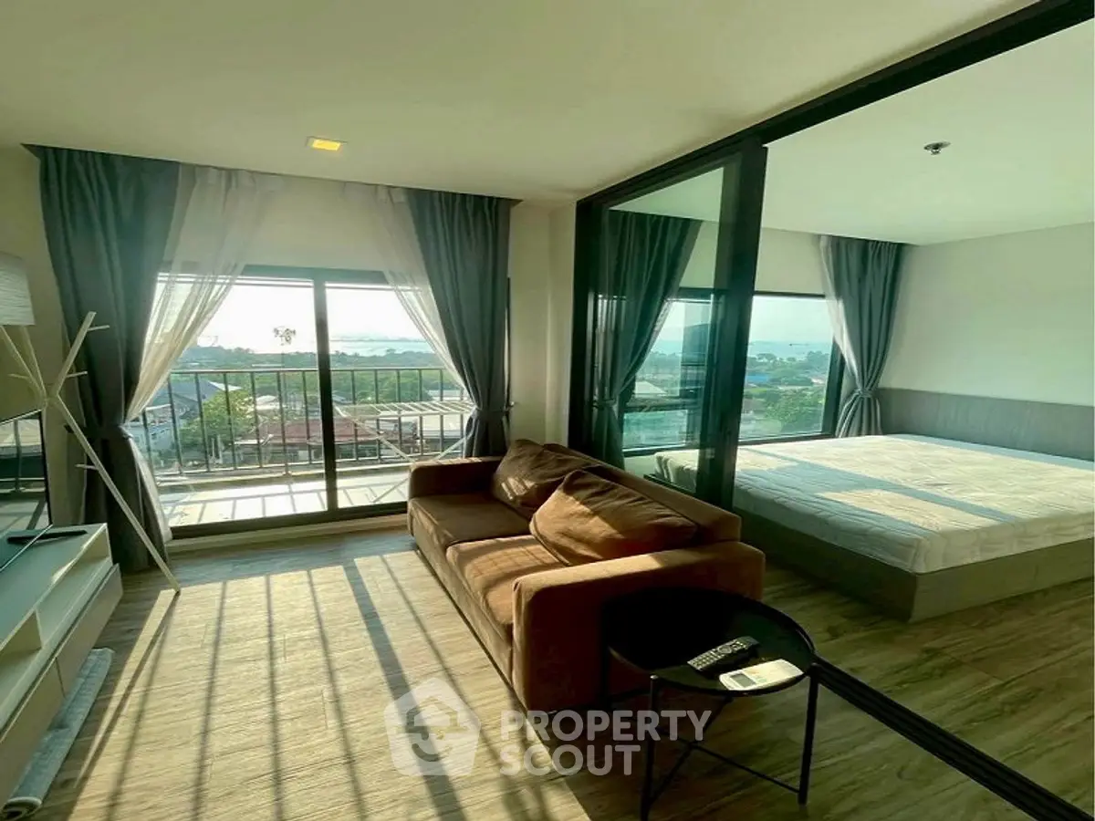 Modern living room with large windows and balcony view