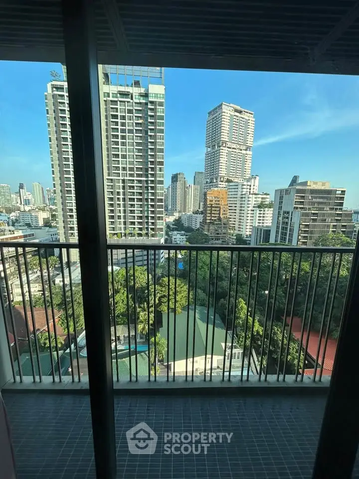 Stunning cityscape view from a high-rise balcony overlooking lush greenery and modern skyscrapers.