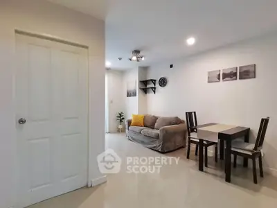 Modern living room with cozy sofa and dining area in a stylish apartment.