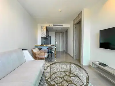 Modern living room with open kitchen and stylish decor in a contemporary apartment.