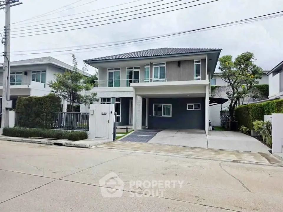 Modern two-story house with spacious driveway and landscaped garden