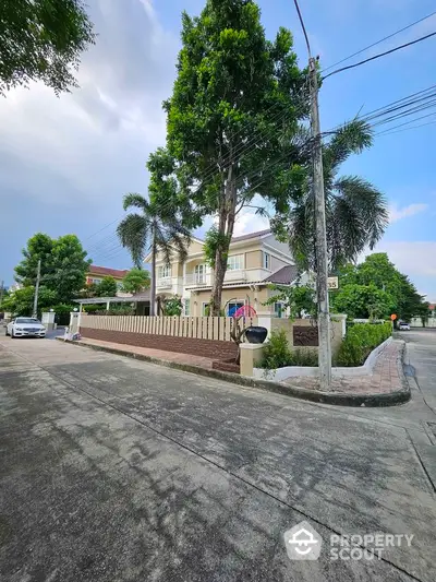 Stunning two-story house with lush garden and modern exterior design in a serene neighborhood.