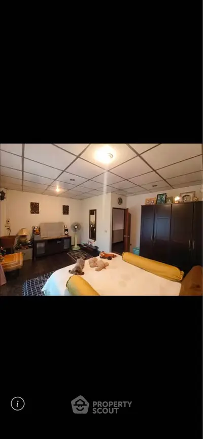 Spacious bedroom with cozy decor and ample storage space, perfect for relaxation and comfort.
