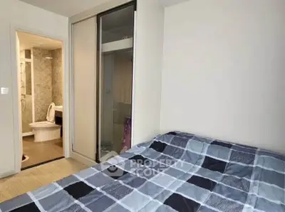 Cozy bedroom with ensuite bathroom and modern sliding closet doors.