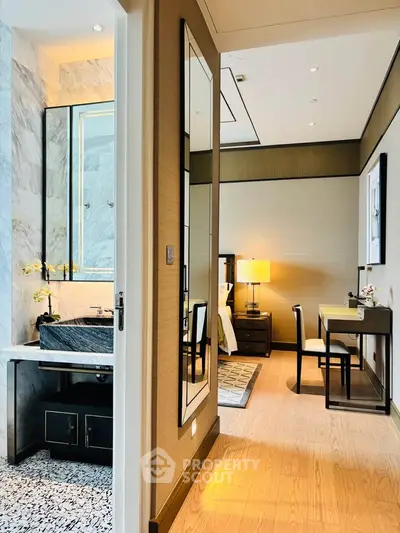 Luxurious modern bedroom with ensuite bathroom featuring elegant decor and stylish furnishings.