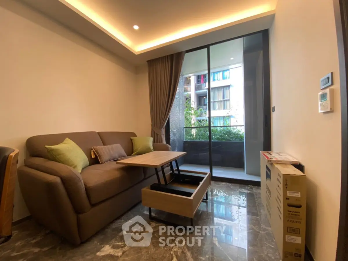 Modern living room with stylish furniture and balcony view in luxury apartment