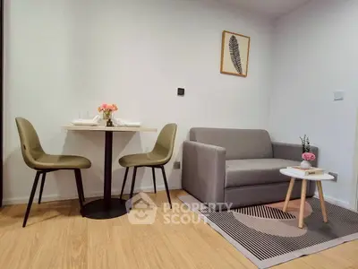 Cozy living room with modern furniture and dining area, perfect for urban living.