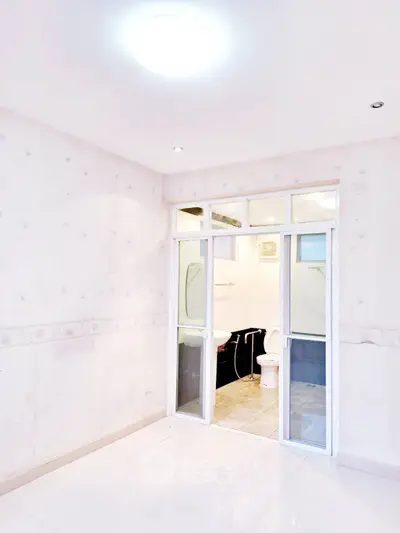 Bright bathroom with sliding glass doors and modern fixtures