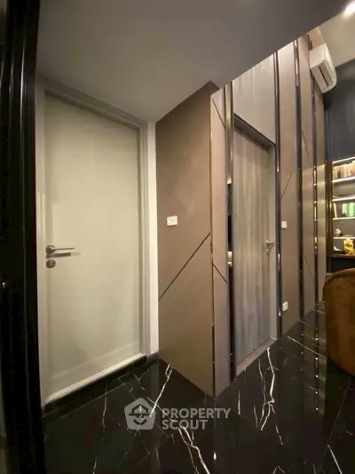 Modern interior with sleek doors and glossy black marble flooring