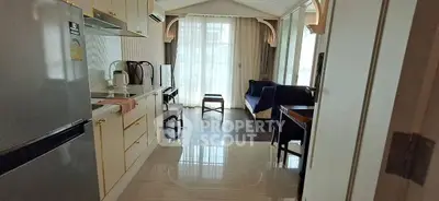 Luxurious open-layout kitchen and living area with elegant furnishings and natural light.