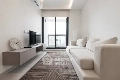 Modern living room with sleek furniture and large window balcony access.