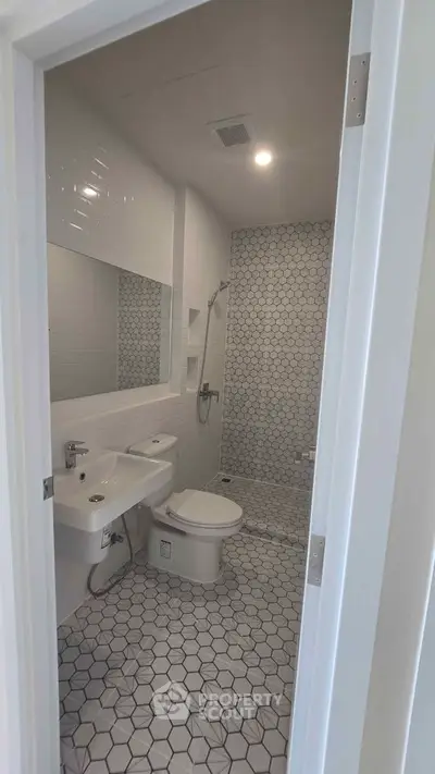 Modern bathroom with hexagonal tiles and sleek fixtures