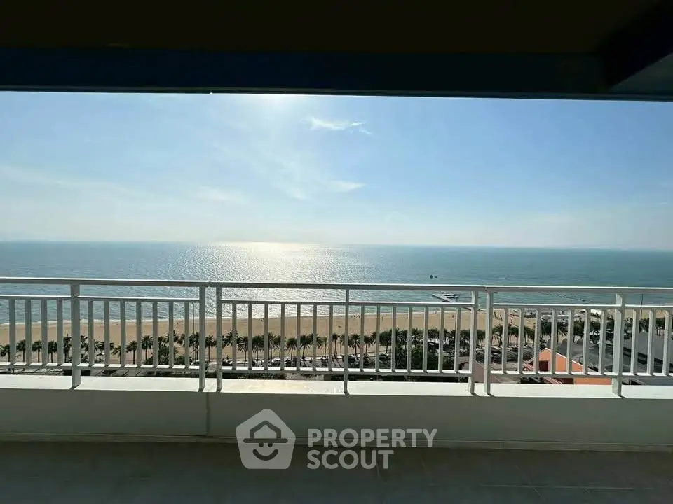 Stunning ocean view from high-rise balcony with clear skies and serene waters.