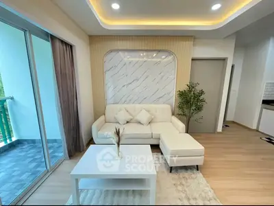 Modern living room with elegant decor and balcony access in a stylish apartment.