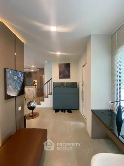 Modern interior with sleek design, showcasing a stylish living area and staircase in a contemporary home.