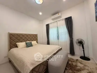 Cozy bedroom with modern decor, featuring a plush bed, elegant curtains, and ambient lighting for a serene atmosphere.