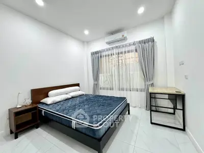 Modern bedroom with sleek design, featuring a comfortable bed and stylish furniture.