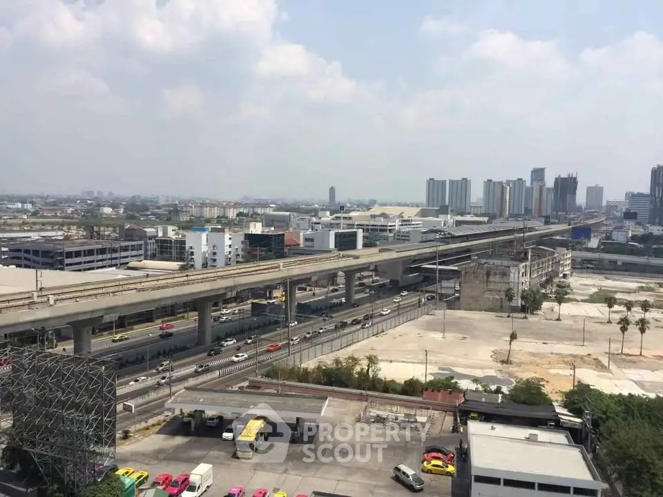 Panoramic cityscape view with elevated highway and urban skyline, showcasing development potential.