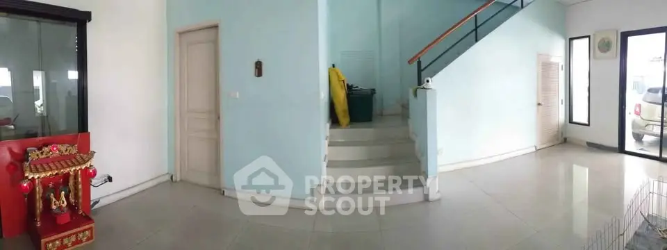 Spacious interior with modern staircase and ample natural light, perfect for versatile living arrangements.