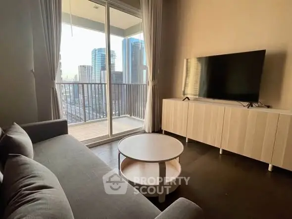 Modern living room with city view, featuring sleek furniture and a spacious balcony.