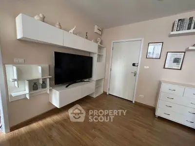 Modern living room with sleek white cabinetry and mounted TV