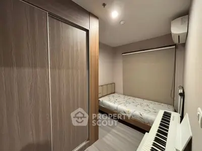 Cozy bedroom with modern wardrobe and air conditioning, featuring a compact layout and stylish decor.