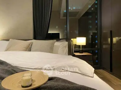 Luxurious bedroom with modern decor and city view, featuring cozy bedding and ambient lighting.