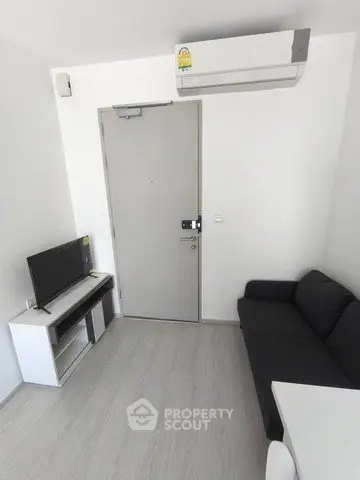 Compact modern living room with sleek furniture and air conditioning