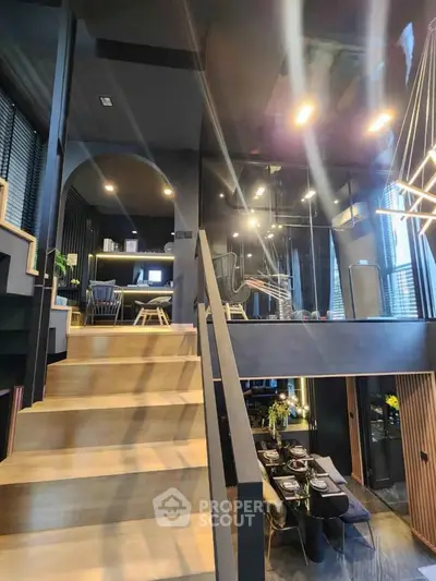 Luxurious modern duplex with elegant dining area and stylish staircase