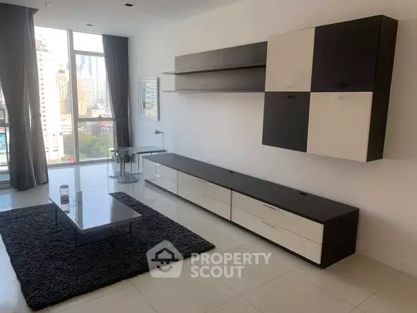 Modern living room with sleek furniture and city view, perfect for urban living.